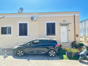 a car parked in front of a house at Al centro del porto in Civitavecchia