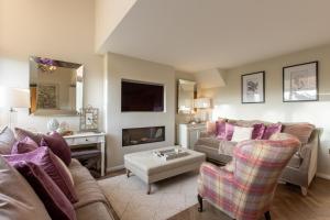 a living room with a couch and a tv at Beech Meadow-Home from Home Luxury Holiday Cottage in Kirkby Lonsdale