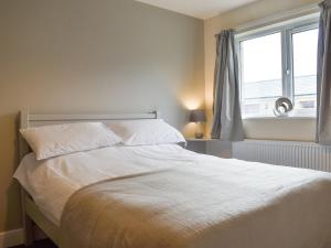 a white bed in a bedroom with a window at Two Dorchester Drive - Uk32036 in Inglewhite
