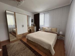 a bedroom with a bed and a large mirror at Къща за гости Здравец  in Trigrad