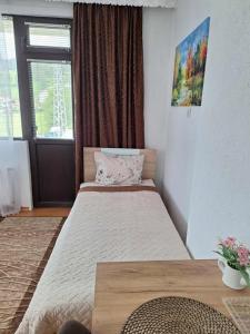 a bedroom with two beds and a window at Къща за гости Здравец  in Trigrad +49 photos