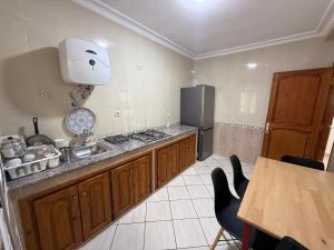 a kitchen with a sink and a refrigerator at Home Together Family in Tetouan