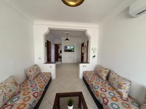 a living room with two couches and a table at Home Together Family in Tetouan +1 photo