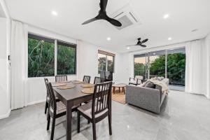 パースにあるScarborough Escape, New 3Br Suite,141のテーブルと椅子とソファのあるダイニングルーム
