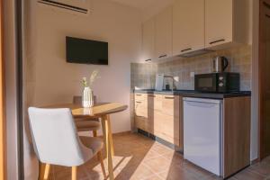a small kitchen with a table and a microwave at MonteHygge apartments in Tivat