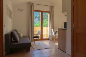 a living room with a couch and a table and a window at MonteHygge apartments in Tivat