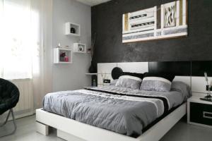 a bedroom with a large bed with a black wall at 3 bedroom villa close to the center with private pool & garden H30 in Begur