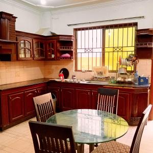 a kitchen with a glass table and chairs in it at Hospitality Hub in Islamabad