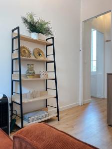 a room with a shelf with plants on it at Quiet and bright apartment with separate bedroom in Nice