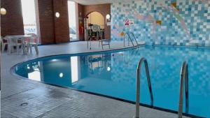 a swimming pool in a hotel with a blue at Beautiful Caravan Phoenix in Saint Margaretʼs at Cliffe