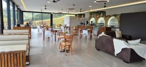 a restaurant with couches and tables and a bar at Ocean Club Zimbali Lakes Resort Ballito B13 in Durban