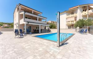 a villa with a swimming pool in front of a building at Beautiful Home In Banj With Wifi in Banj +27 photos