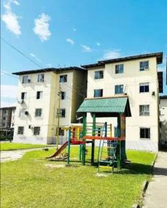 a playground in front of a large building at Residencial Privê Sol Tropical in Belém