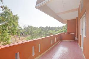 an empty balcony of a building with a large window at Hotel O Stayz in Auroville +37 photos