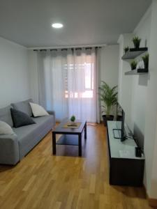 Una sala de estar con un sofá y una mesa de café. en apartamento vilariño, en Cangas de Morrazo