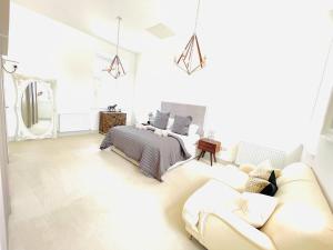 a white bedroom with a bed and a couch at Great Glen Townhouse Inverness - Entire 3 Story Townhouse in Inverness