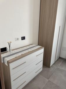 a bathroom with a white counter top in a room at Domus Aura Apartments in SantʼAntìoco