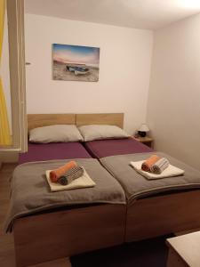 a bedroom with a bed with two pillows on it at Studio apartment Dragana in Sobra +14 photos