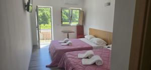 two beds with towels on them in a room at Vale do Rodo Residencial in Peso da Régua