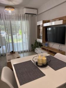 a living room with a table with candles and a television at The Candy House in Ofrínion