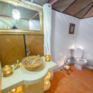 a bathroom with a sink and a toilet at Merzouga camp in Merzouga