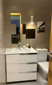 a bathroom with a white sink and a toilet at Appartement familial in Casablanca