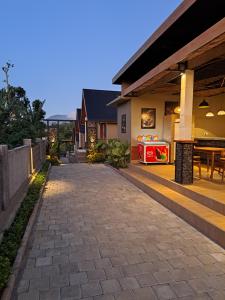 a walkway in front of a house with a patio at Air ilir grand villa in Gitgit