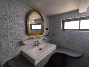a bathroom with a sink and a mirror at Secret Garden Villa Bandarawela in Bandarawela +30 photos