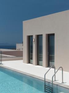 a building with a swimming pool in front of it at Alon Sevou Boutique Hotel in Sivota