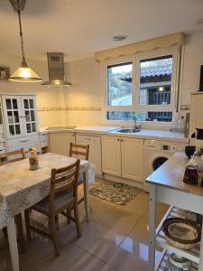 a kitchen with a table and chairs and a sink at Casa el EDEN de Cameros in Laguna de Cameros +39 photos