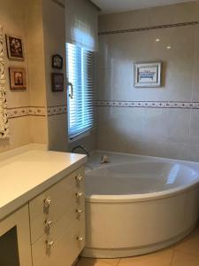 a white bath tub in a bathroom with a window at Casa el EDEN de Cameros in Laguna de Cameros
