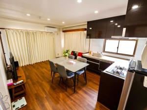 a kitchen and dining room with a table and chairs at Three minutes walk to subway Direct to the airport Umeda business district in Osaka