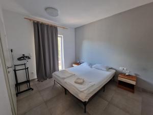 a bedroom with a white bed and a window at SUBTUB Hostel Makarska in Makarska +63 photos