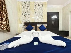 Voodi või voodid majutusasutuse Hotel Jasmine Paldi Ahmedabad toas