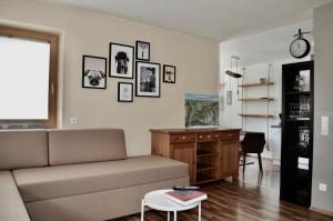 a living room with a couch and a table at Hollys Ferienwohnungen in Gerlos +12 photos