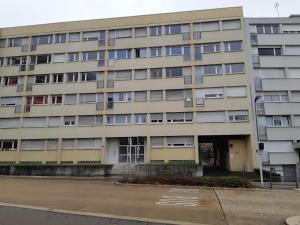 a large apartment building with a parking lot in front of it at Gabcha in Metz