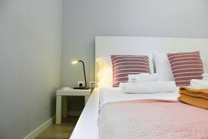 a bedroom with a bed and a table with a lamp at Apartamentos do Parque in Vila Real