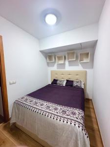 a bedroom with a bed in a white room at Sa Boadella - Fenals Beach in Lloret de Mar +20 photos