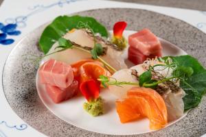 a white plate of food on a table at KAMENOI HOTEL Genkainada in Kitakyushu
