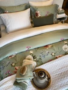 a bedroom with a bed with a flowery wallpaper at Bed & Breakfast The Konoba in Šibenik +4 photos