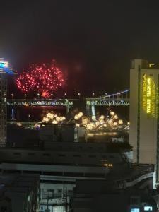 a view of a bridge with fireworks at night at Gwangan The L in Busan +8 photos