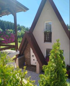 a small house with a window and a balcony at Zlatar Eyes in Nova Varoš +43 photos