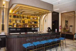a bar with blue stools in a restaurant at The Thribeka International Hotel Asaba in Asaba