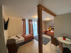 a bedroom with two beds and a table and chairs at Eurybia in Łeba +45 photos