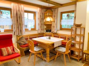 a dining room with a wooden table and chairs at Ferienwohnung Königsleiten 251 - Top EG in Königsleiten +3 photos