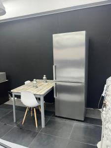 a kitchen with a table and a refrigerator at Ευρύχωρος χώρος φιλοξενίας in Xanthi