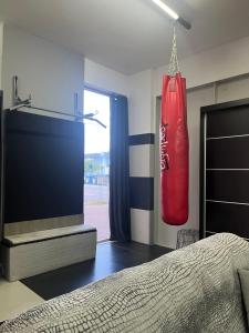 a bedroom with a red boxing glove hanging from the wall at Ευρύχωρος χώρος φιλοξενίας in Xanthi