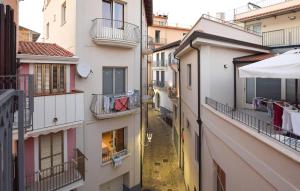 an alleyway between two buildings with clothes hanging from balconies at Beautiful Apartment in Santa Maria di Castellabate