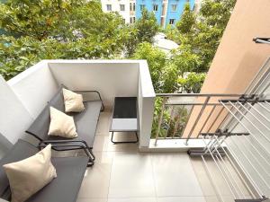 a balcony with a couch and a table on a balcony at Urban Stays by Empress in Hulhumale