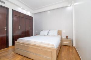 a bedroom with a bed and a wooden cabinet at Mamounia Horizon in Casablanca